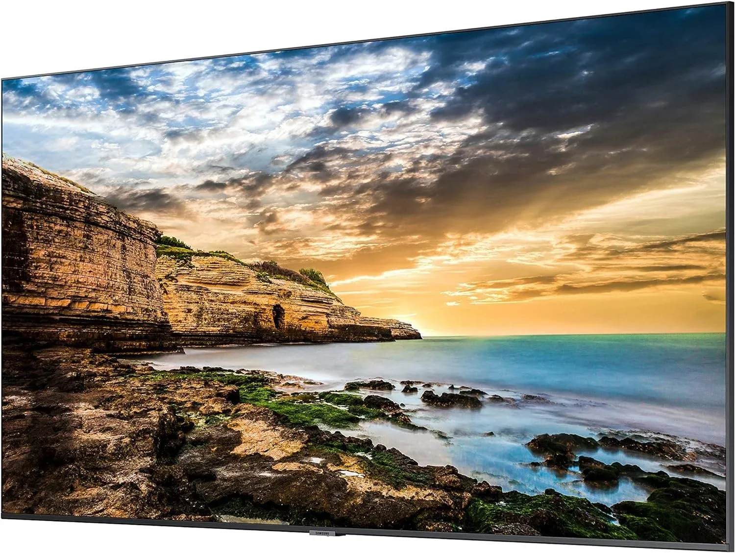 A Samsung commercial display showing a coastal landscape photo